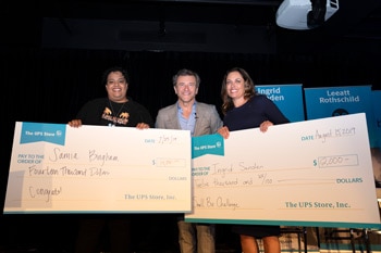 Robert Herjavec (middle) presents Small Biz Challenge winners Samia Bingham and Ingrid Sanden with their grand prize checks.