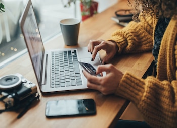 person on a laptop with a credit card