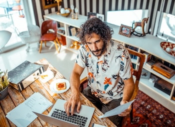 man working on a laptop at a desk