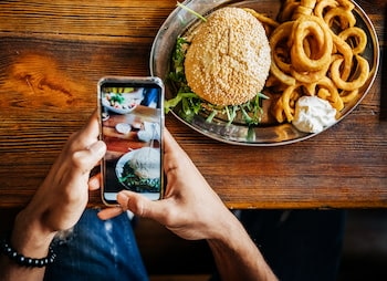 person on their mobile device at a restaurant