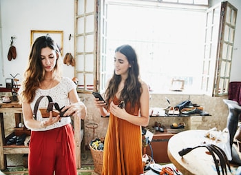 two women looking at shoes