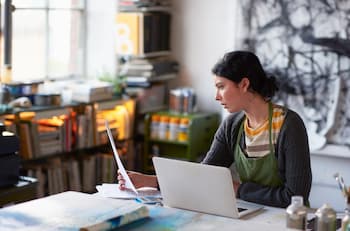 woman managing finances on her laptop