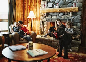 family relaxing around fireplace