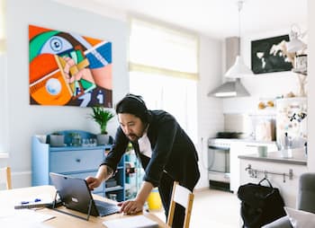 man on conference call in kitchen