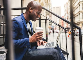 male business checking email with morning coffee