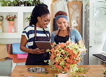 Two women working together at a flower store