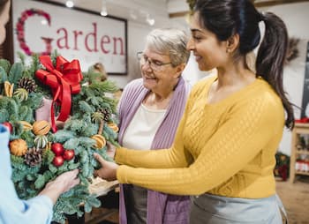 store staff decorates for holidays