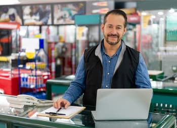 male store owner at customer service counter