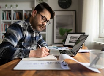 man works on his small business budget