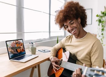 Guy is playing the guitar 