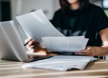 Woman looks over tax papers.