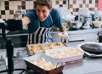 person baking and taking photos