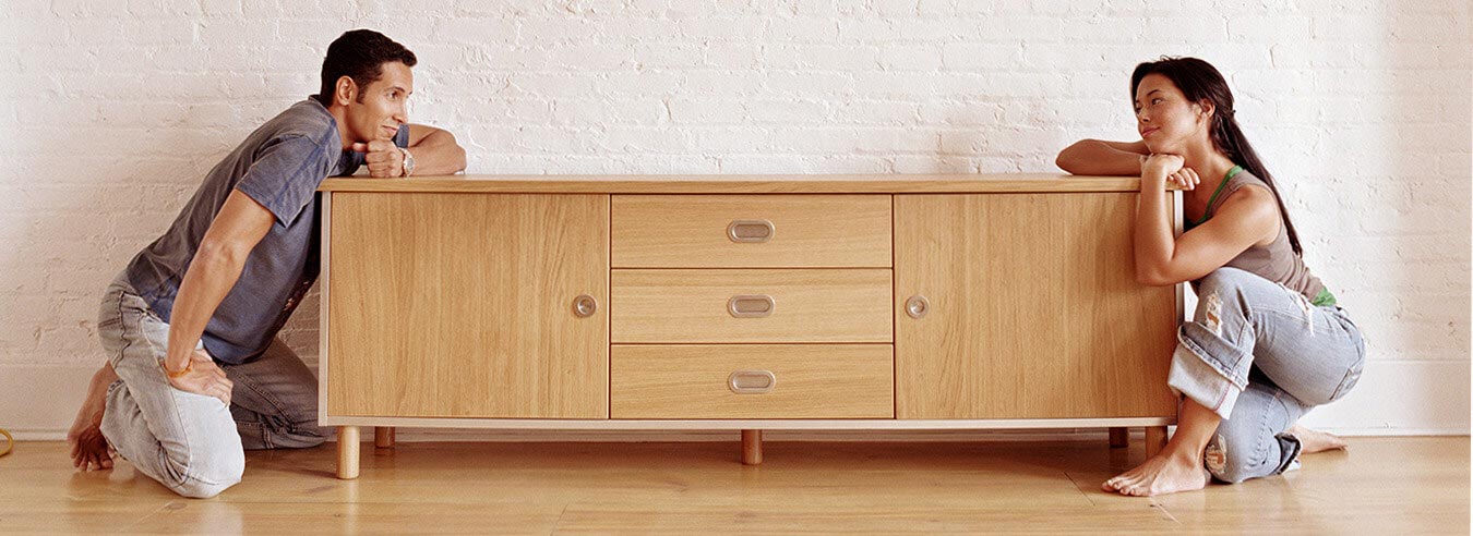 Couple kneeling on either end of sideboard