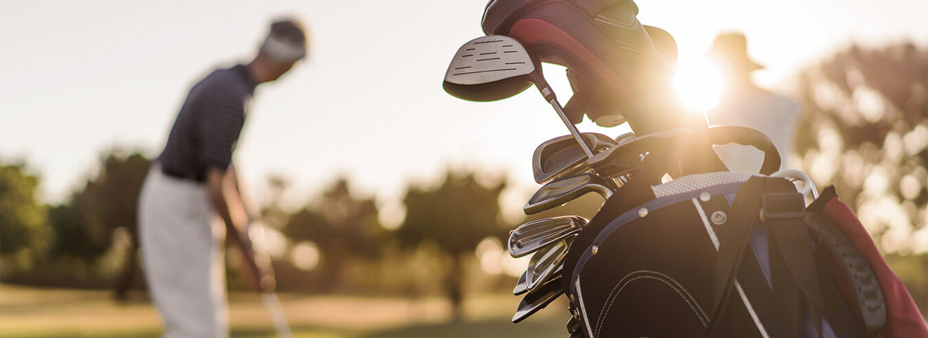 Golfer on the links with golf bag in foreground