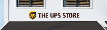 The UPS Store sign on a white building