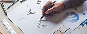 Man's hand drawing a business logo