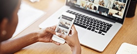 Woman using phone and laptop to view business website