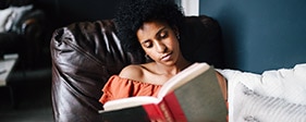 Woman in a chair reading a book