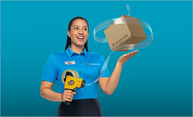Woman holding up a taped package