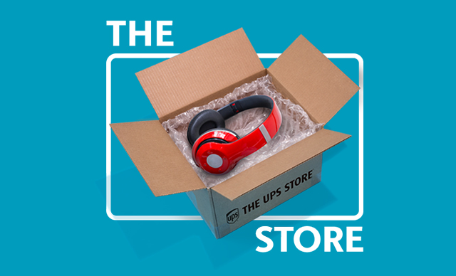 A pair of red headphones wrapped in bubble wrap in The UPS Store box and bounding box. 
