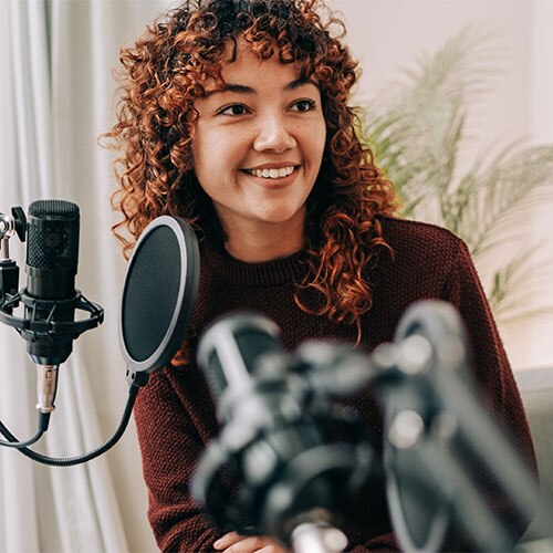 Woman smiling in front of a microphone