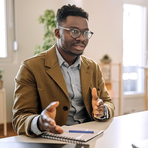 Man in business attire being interviewed