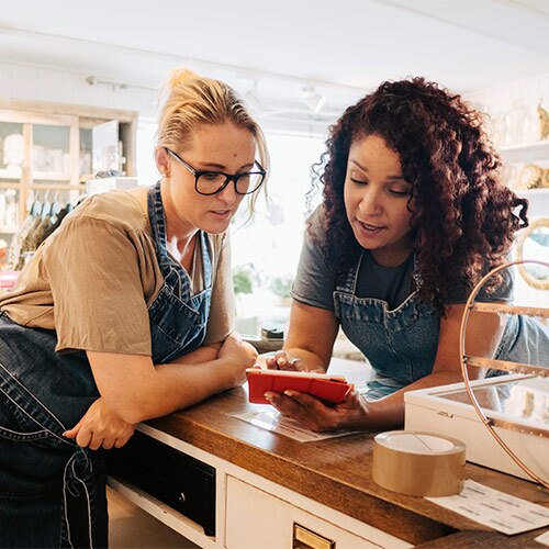 Two women looking at a cell phone