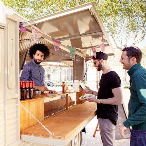 Two men ordering from a food truck
