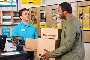 Customer handing associate a box