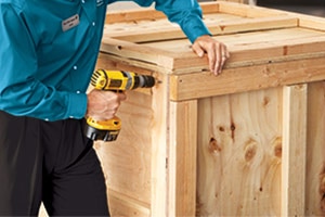 Associate placing table into crate