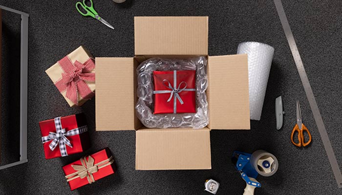 Holiday gift and wrapping inside a shipping box